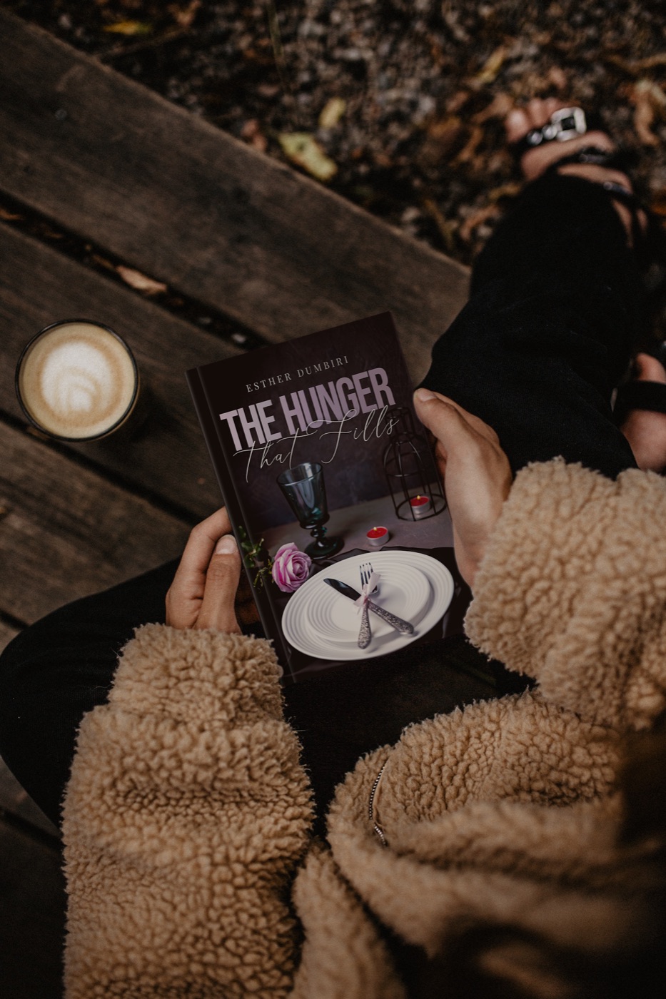 A reader holding The Hunger That Fills